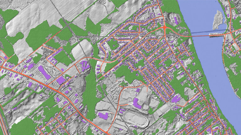 Digitized roads, buildings, forested areas and water overlaying an elevation model in Woodstock, New Brunswick.